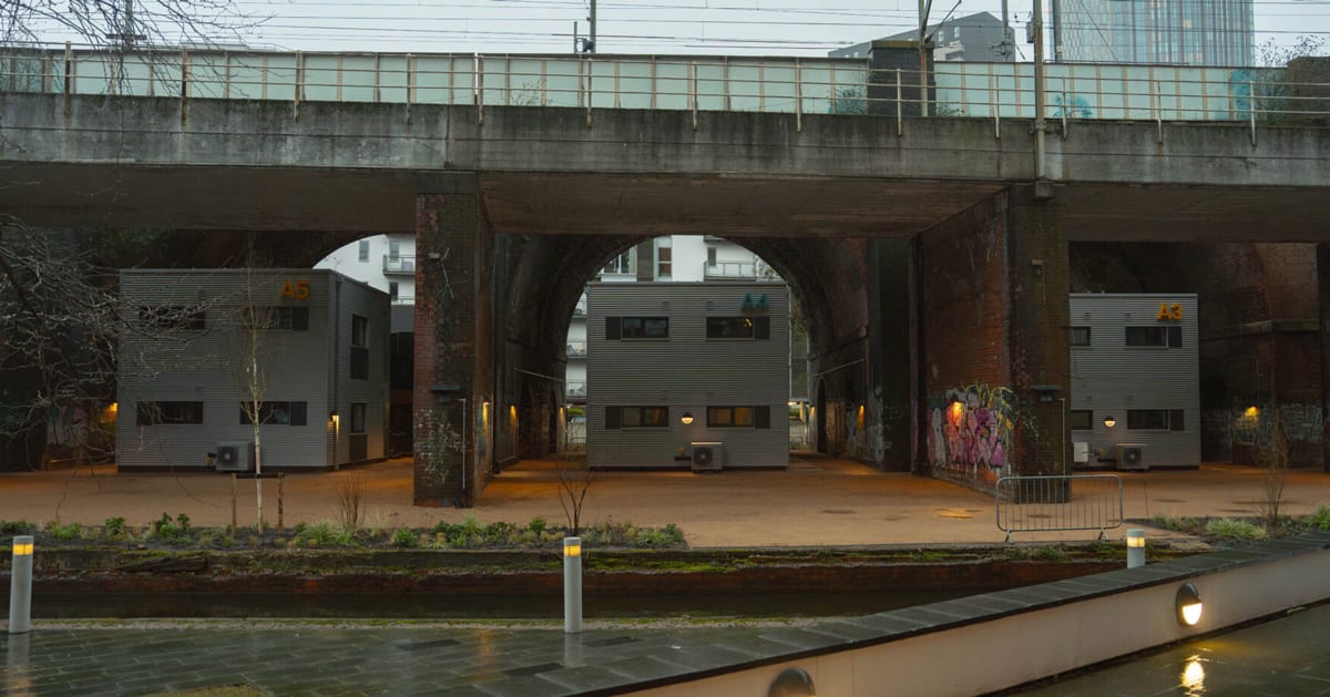 Fully furnished housing unit with kitchen and bathroom in Manchester's Embassy Village beneath railway arches
