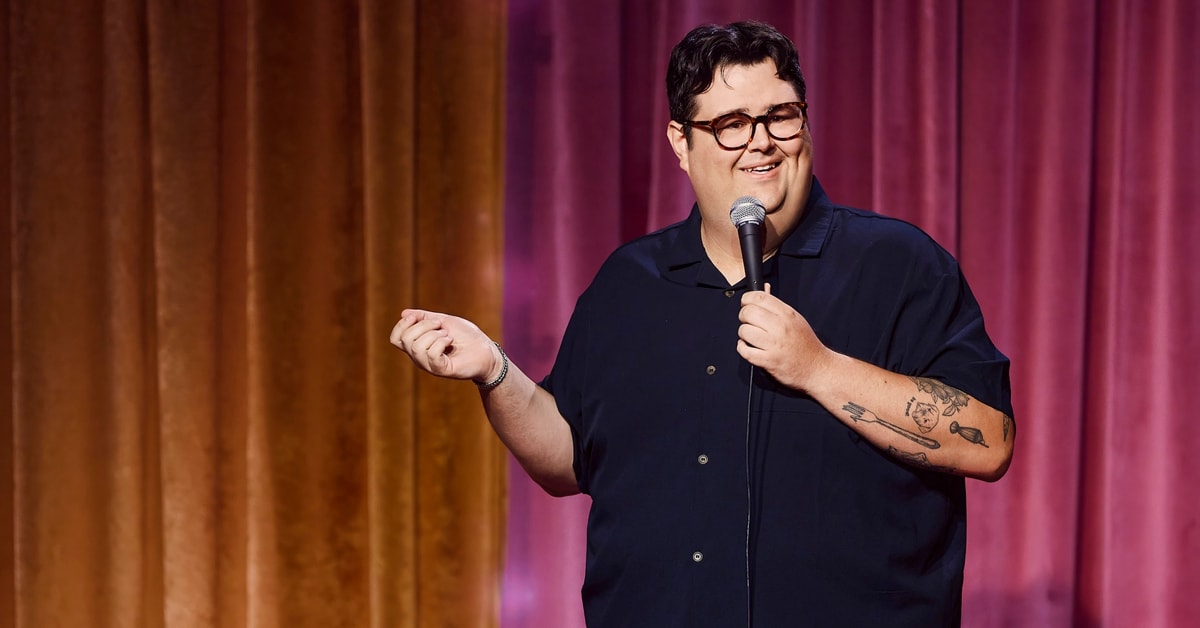 Comedian Caleb Hearon performing standup on the set of his HBO special Model Comedian