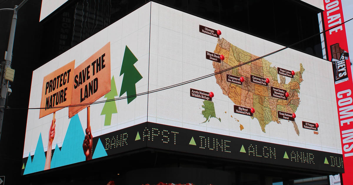 Live stock market ticker in Times Square displaying participation numbers for national parks campaign