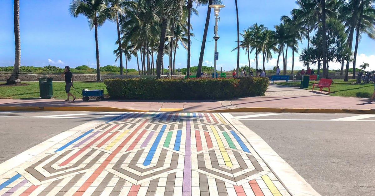 Colorful rainbow pavers arranged in crosswalk pattern on Ocean Drive, Miami Beach