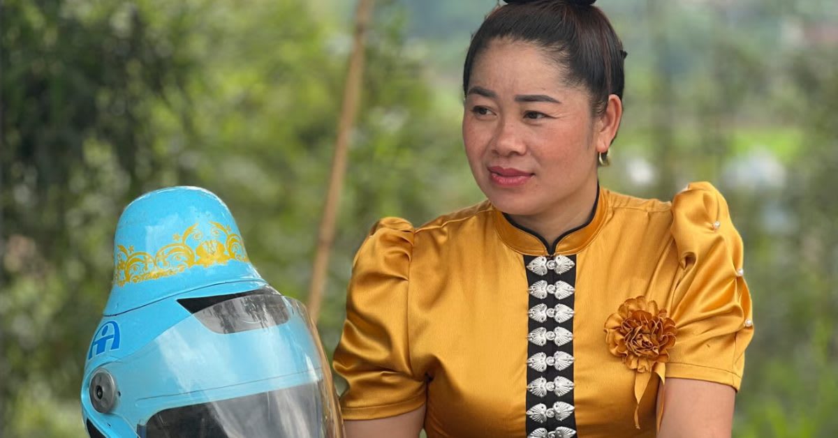 Thai woman wearing specially designed motorcycle helmet that accommodates traditional high bun hairstyle in Vietnam