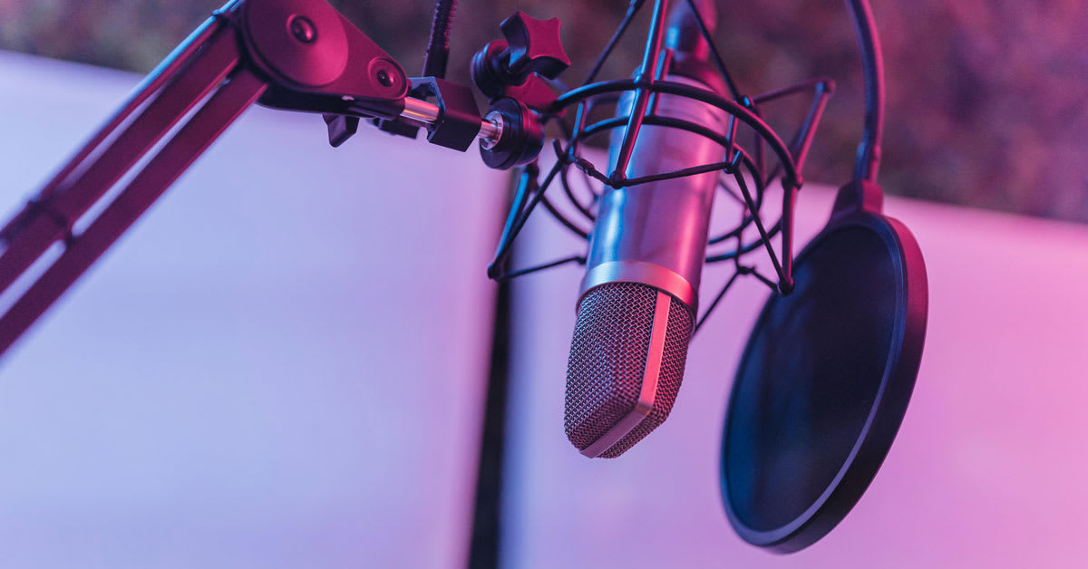 Bernie Wagenblast speaking into microphone at New York City subway station recording booth