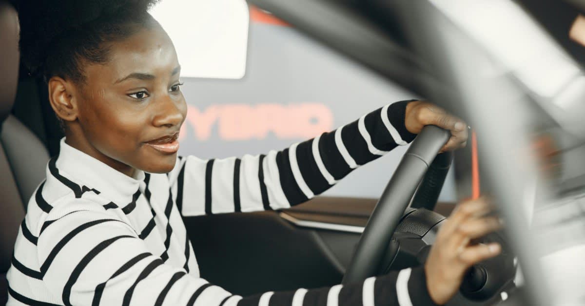 Woman using smartphone to request rideshare transportation service at night