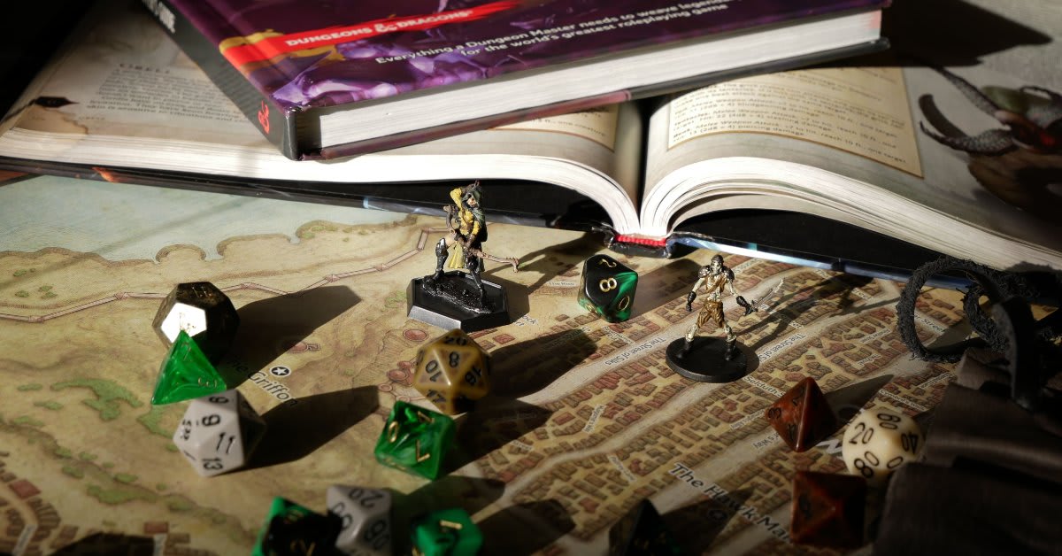College students sit around table playing Dungeons and Dragons during group therapy session