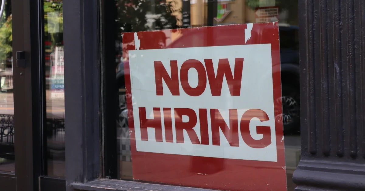 Professional reviewing job posting with visible salary range on computer screen