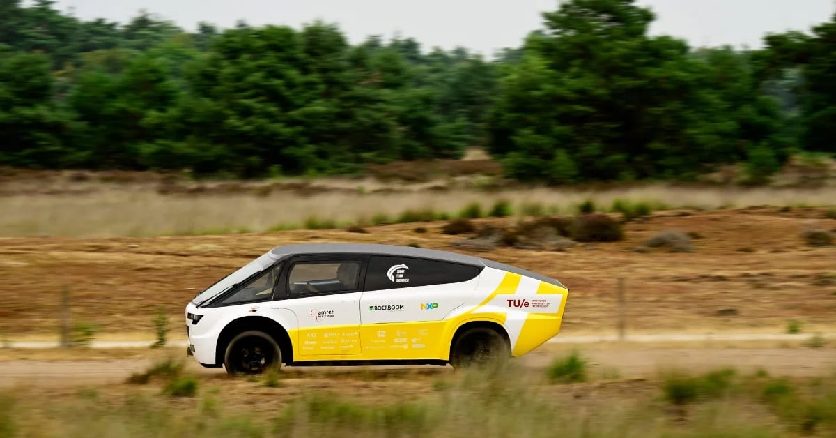 White futuristic solar-powered ambulance with large roof panels parked outdoors in Netherlands