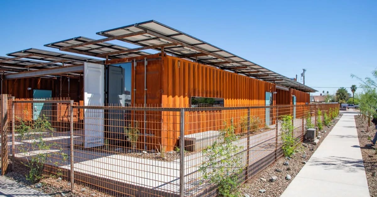Modern shipping container housing units with solar panels at Senior Bridge Phoenix opening ceremony