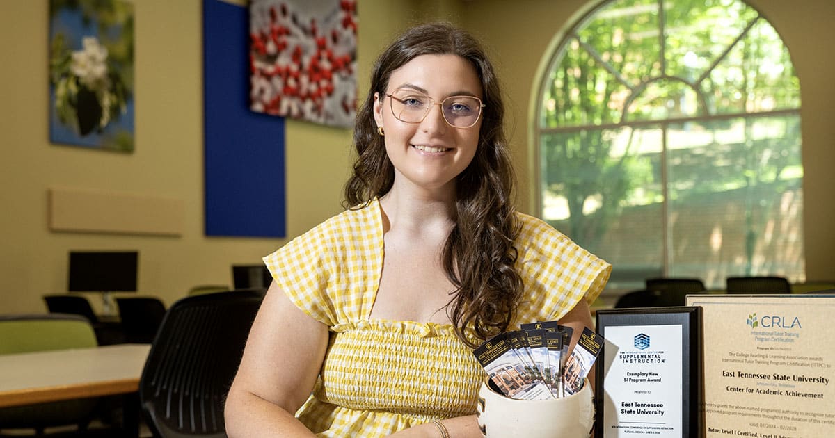 College student Hannah Tate Gulley smiling while helping peers at ETSU academic support center