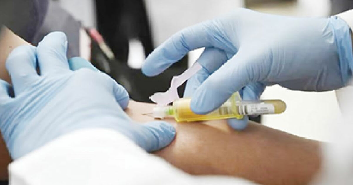 Healthcare worker conducting prenatal screening with pregnant woman in Nigerian health facility