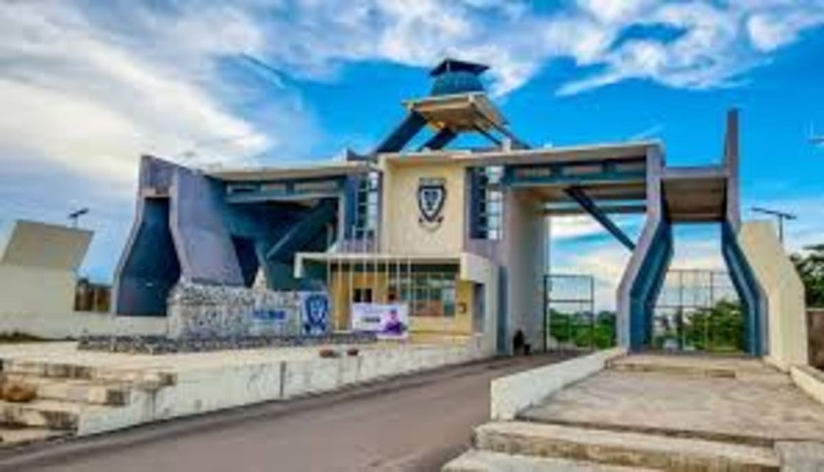 Students walking across Federal University Lokoja campus in Nigeria under sunny skies