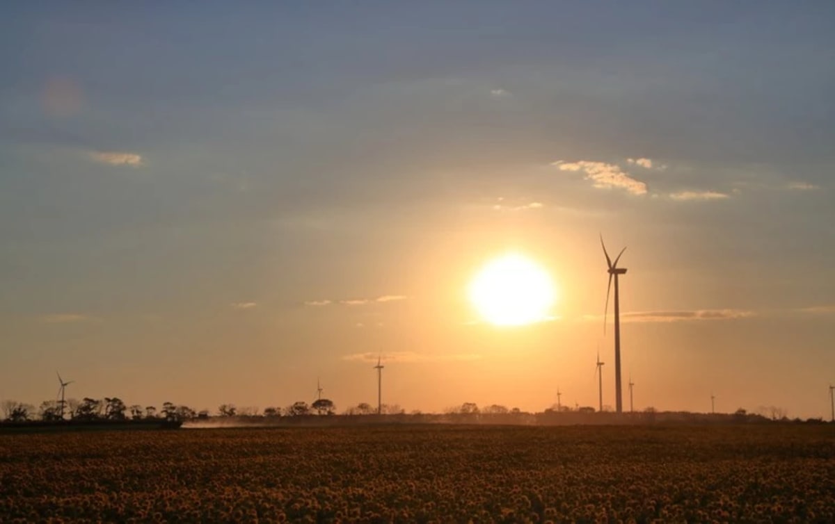 Modern wind turbines standing tall against sky in rural Bavarian landscape