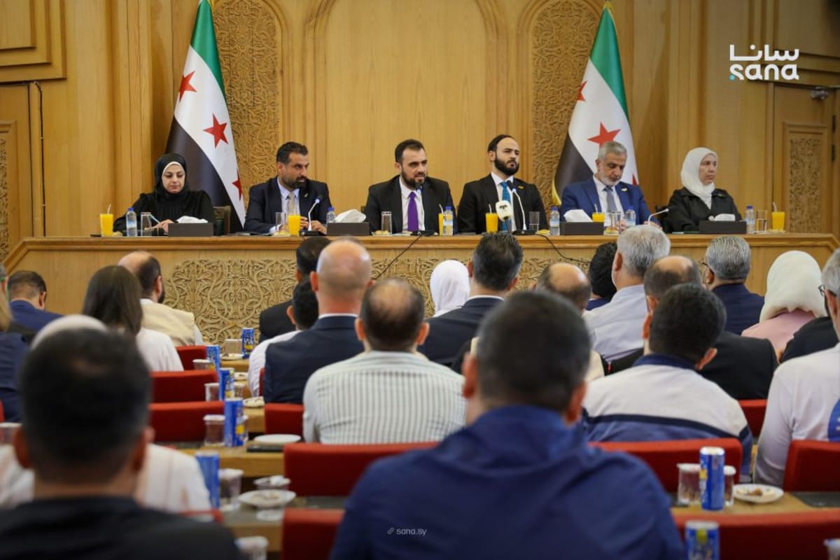 Government officials and aid organization representatives meeting in Aleppo conference hall to discuss humanitarian coordination
