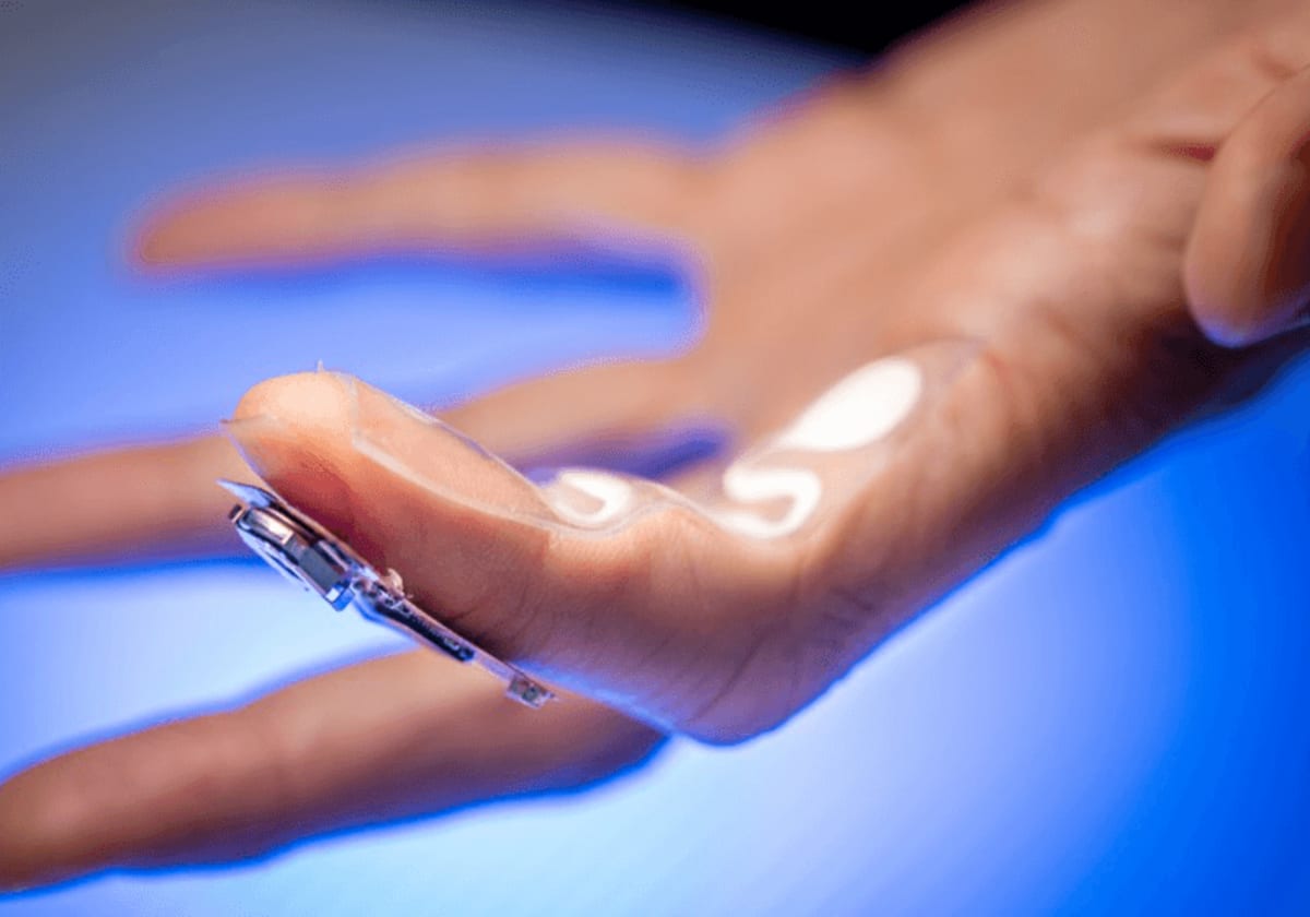 Small wearable medical patch attached to person's fingertip monitoring medication levels through sweat