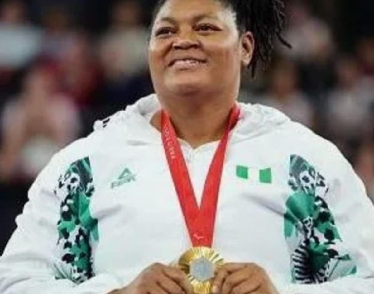 ** Folashade Oluwafemiayo competing in para powerlifting competition wearing Nigeria team uniform