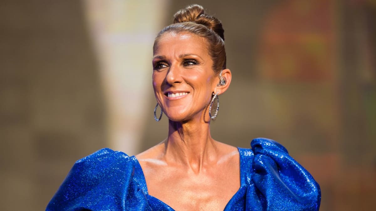 Celine Dion smiling in professional portrait after announcing her return to performing