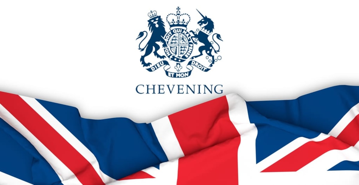 ** Diverse group of international students celebrating at UK university graduation ceremony