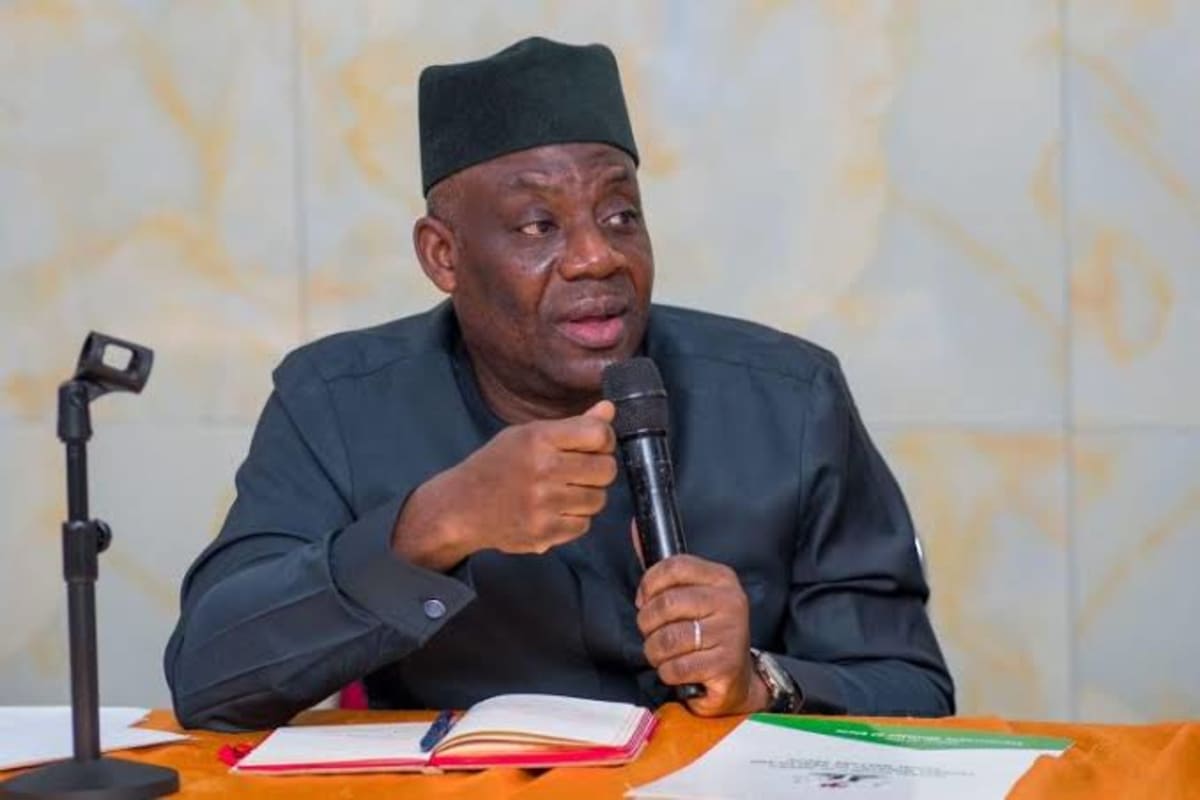 Nigerian students taking computer-based exams at government school desks with digital monitors