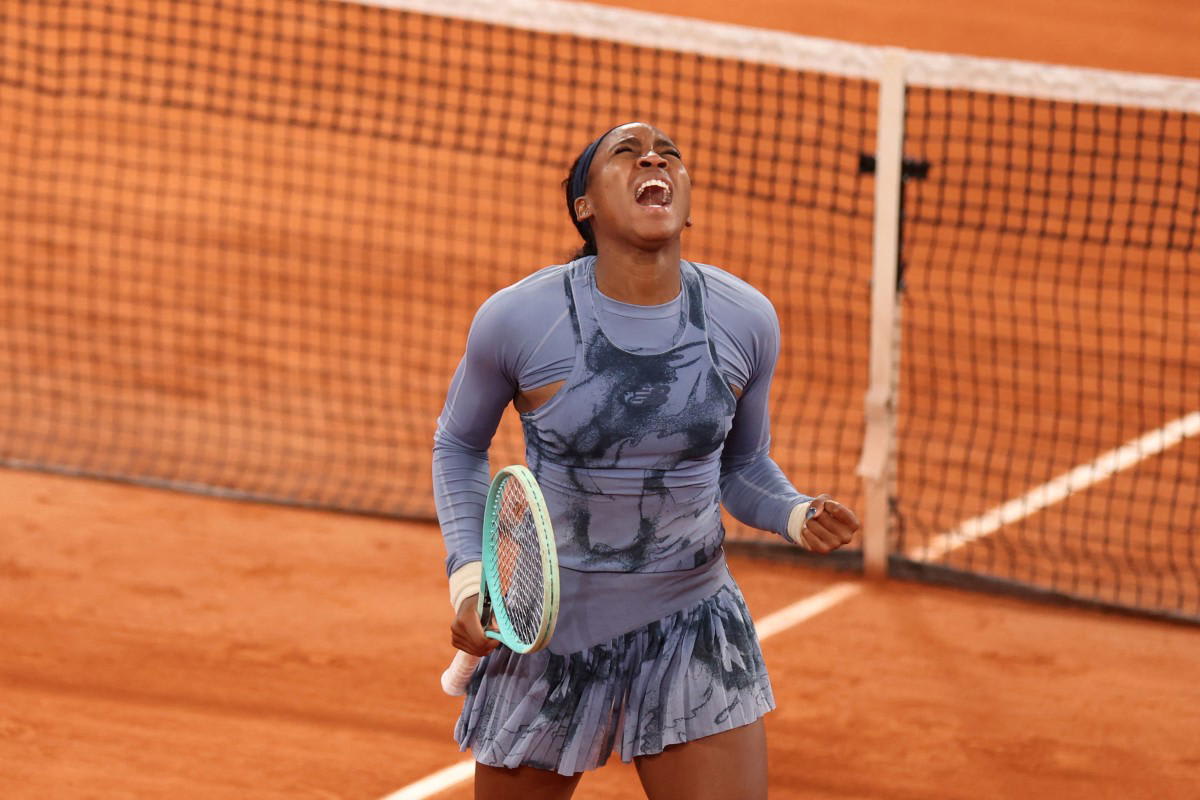 Tennis player Coco Gauff celebrates victory at French Open on red clay court