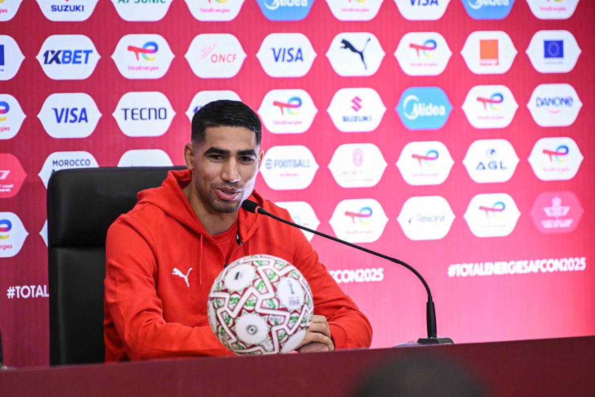 Morocco national team captain Achraf Hakimi in red team jersey during football match