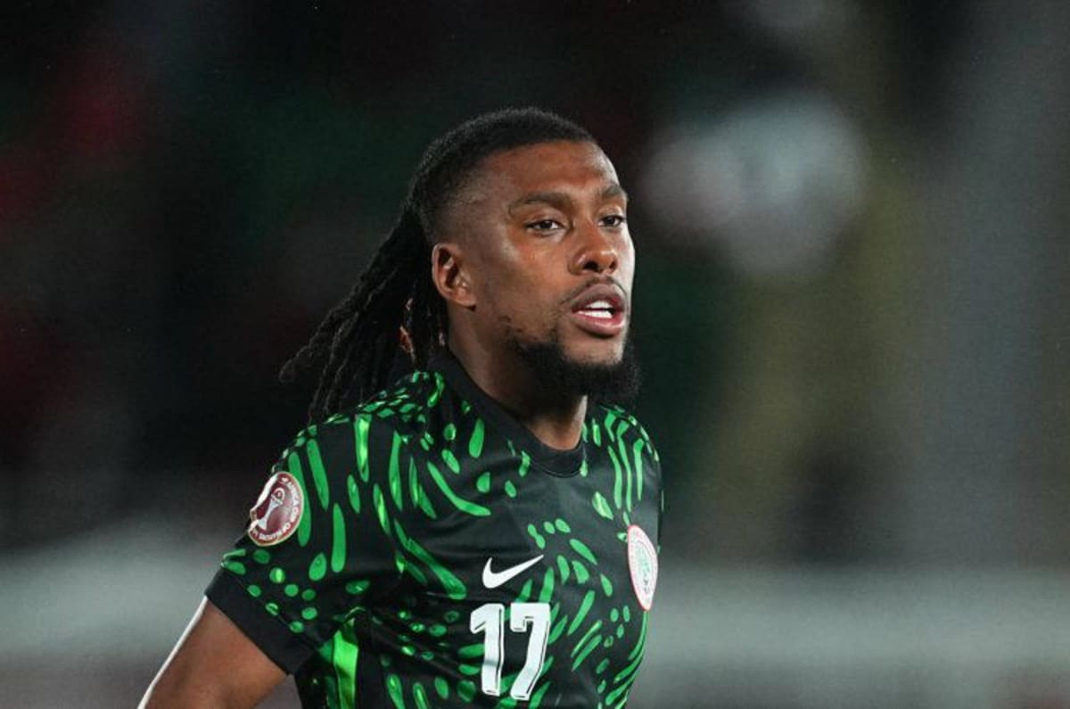Alexander Iwobi in Nigeria's green and white Super Eagles jersey celebrating on the football pitch