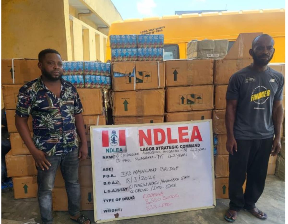 Nigerian drug enforcement officers examining seized contraband hidden in shipping materials and clothing