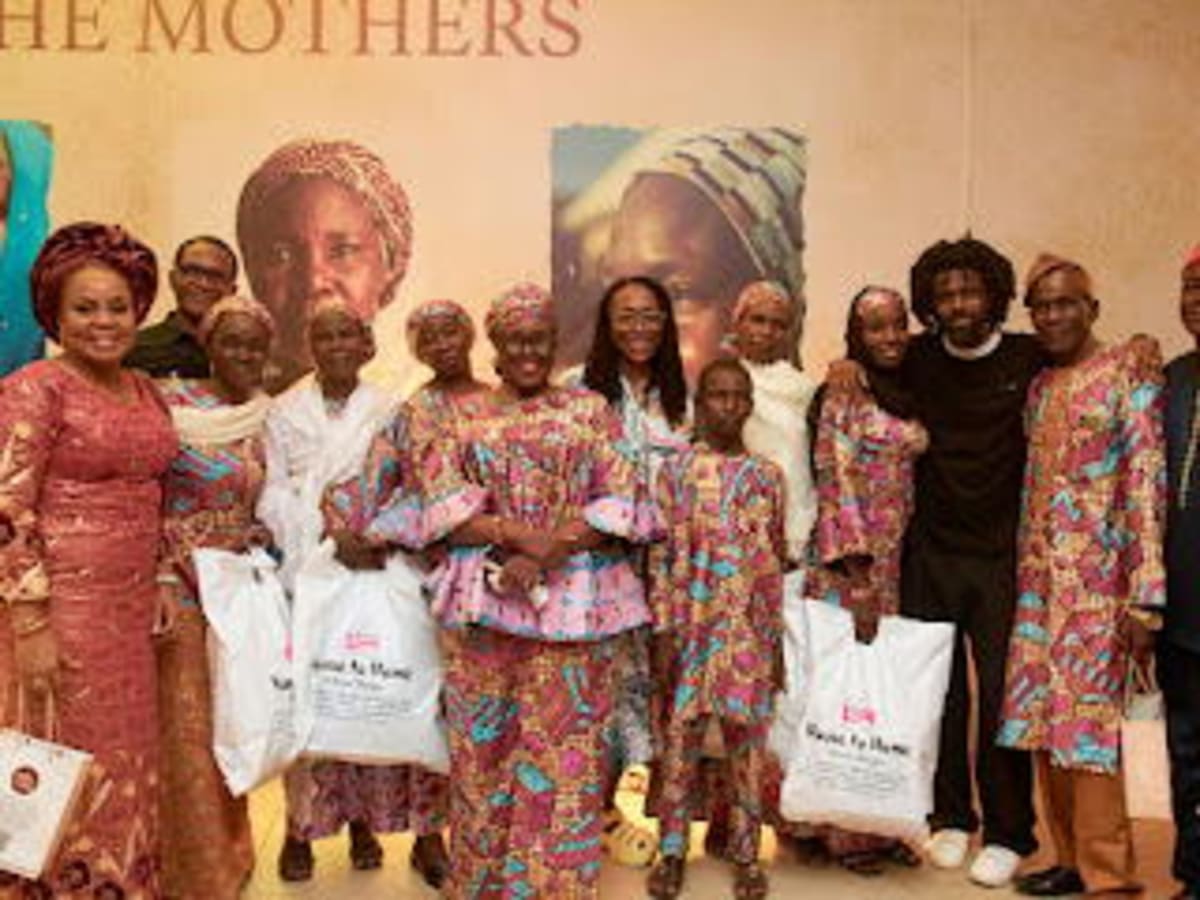 Chibok mothers stand with documentary filmmaker Joel Kachi Benson at Lagos film premiere