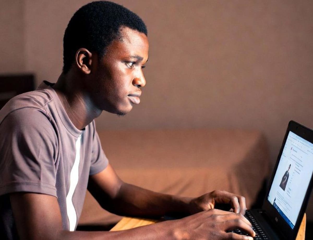 Nigerian students using mobile phones and tablets to access online educational content in a classroom setting
