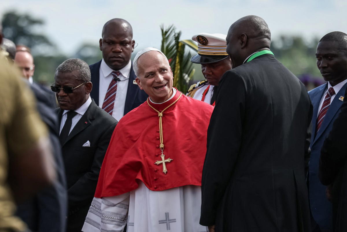 Pope Leo XIV blessing crowds from open-top car in Yaounde, Cameroon surrounded by celebrating faithful