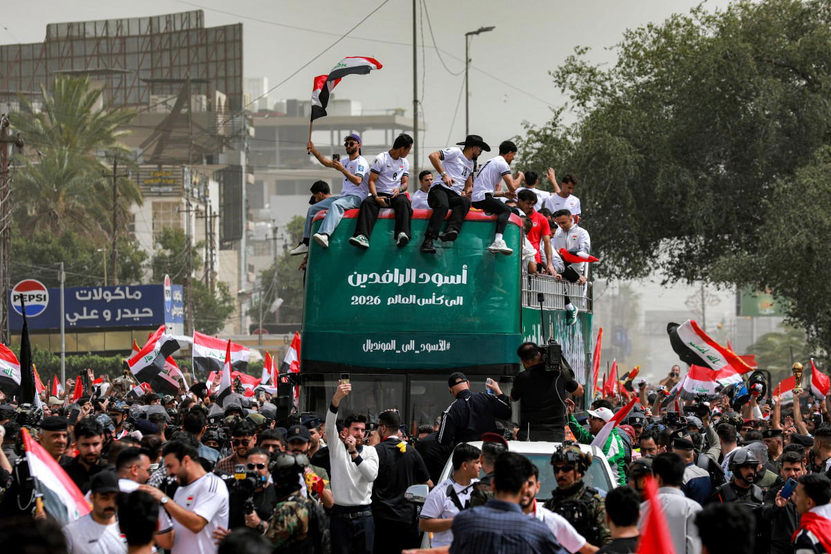 Iraqi national football team celebrates on double-decker bus with thousands of fans in Baghdad