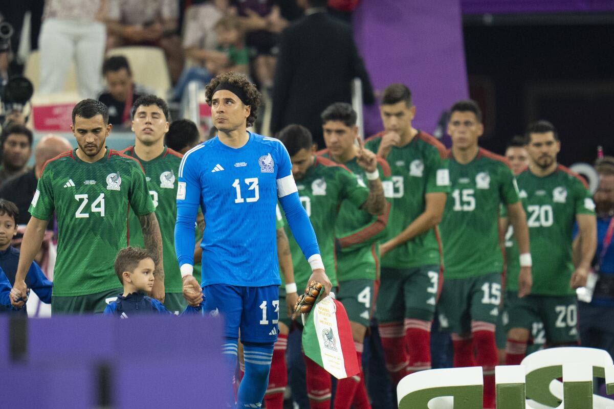 Mexican national soccer team players in green jerseys celebrating during World Cup qualifying match