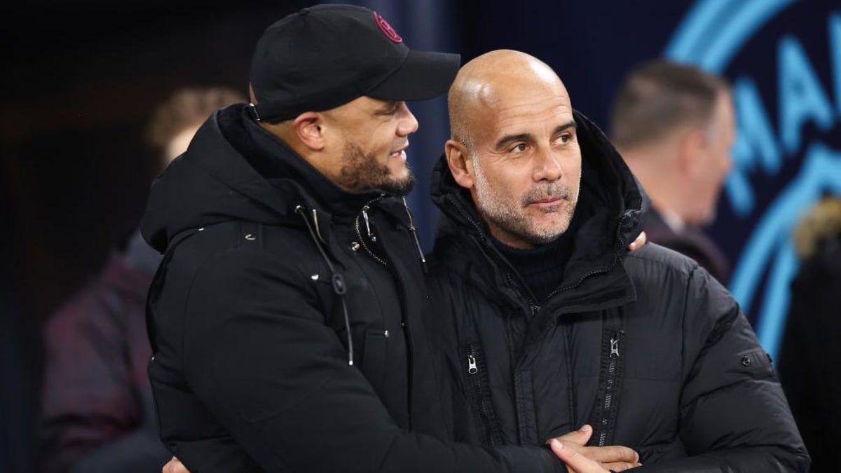 Vincent Kompany and Pep Guardiola standing together during their time at Manchester City