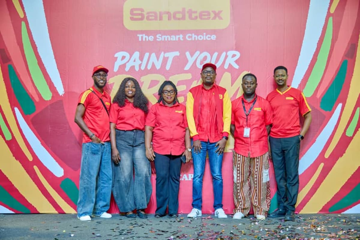 Nigerian students displaying colorful paintings of future communities at award ceremony in Lagos