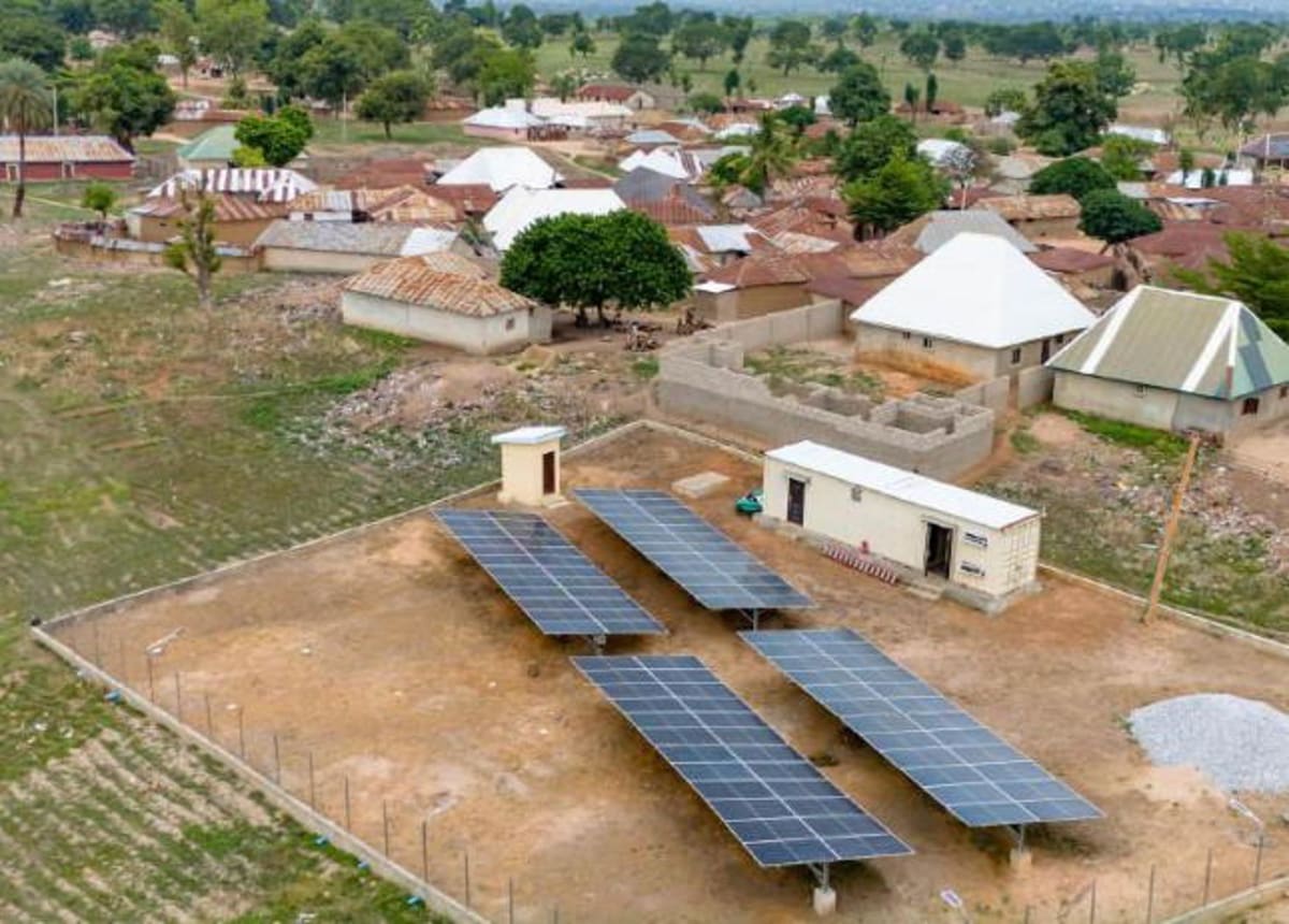 Nigerian town of Ajuye illuminated at night by solar-powered street lights and homes