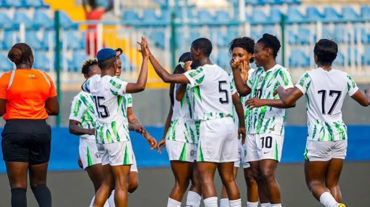 Nigeria's Super Falcons women's football team celebrating together in green uniforms