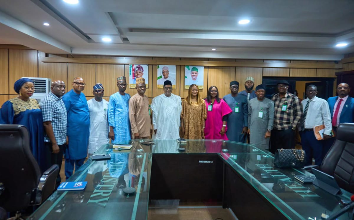 Healthcare workers and officials discussing digital identity integration for Nigeria's health system transformation