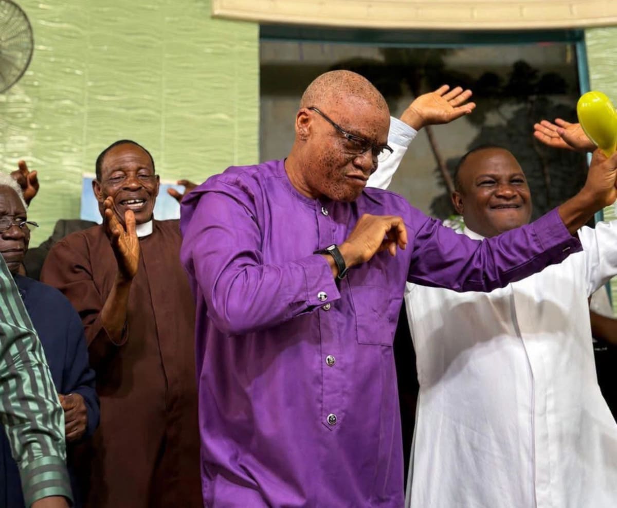 Nigerian professor dancing joyfully during church thanksgiving service celebrating wife's safe return from captivity