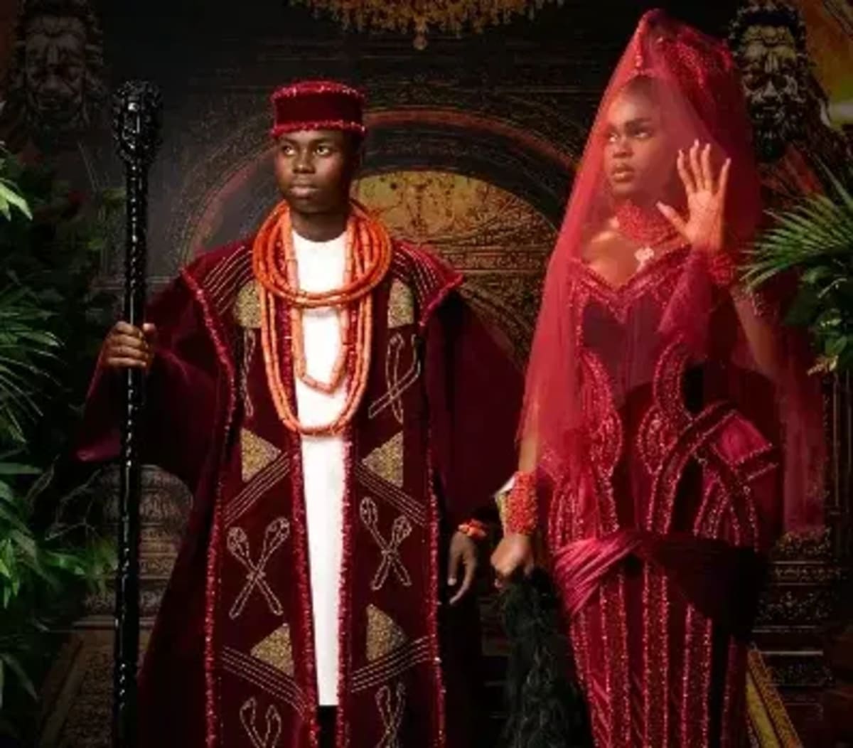 ** Nigerian content creators Peller and Jarvis in traditional Benin wedding attire smiling together