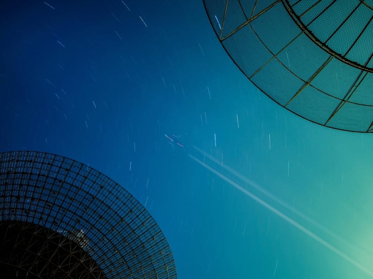 Faint trail of stars stretching across a distant galaxy revealing hidden dark matter