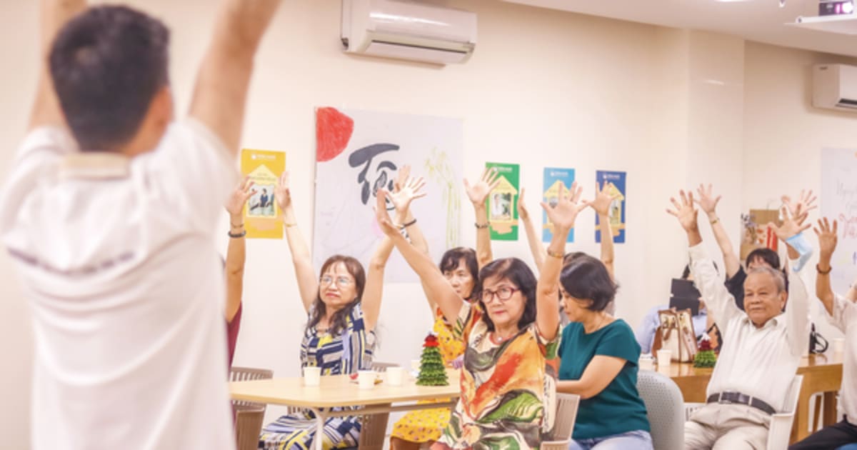Elderly Vietnamese residents participating in social activities at modern care facility in Ho Chi Minh City
