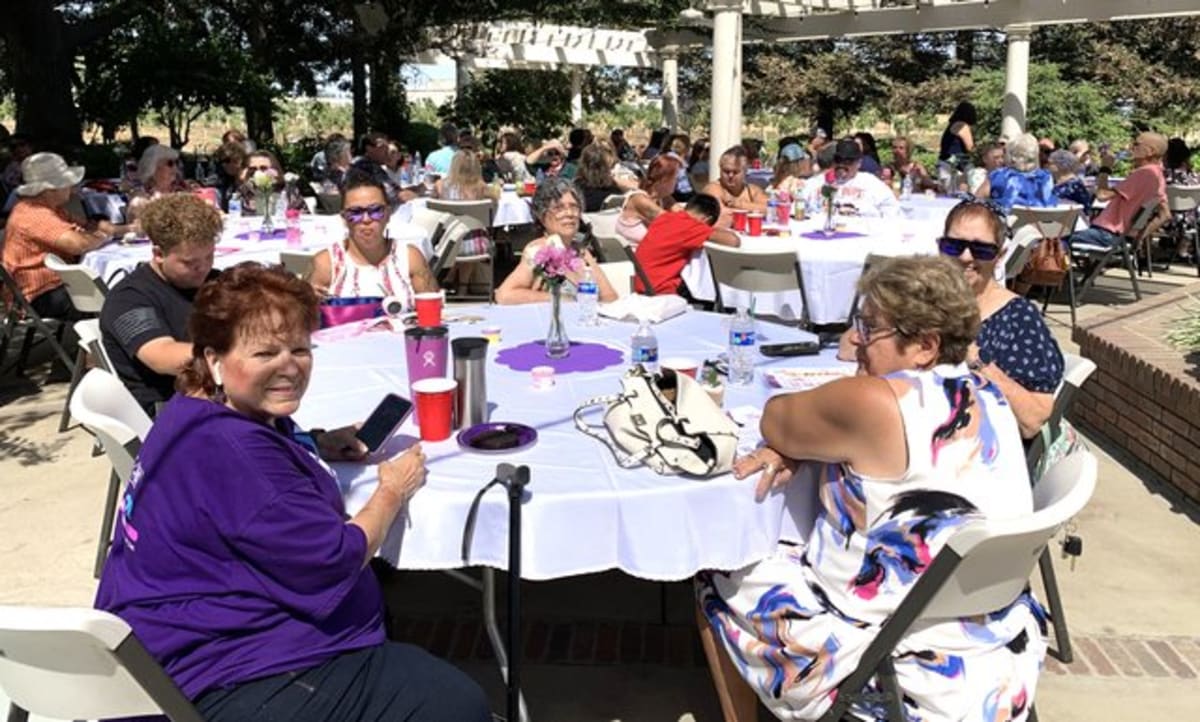 Cancer survivors and caregivers gather at outdoor luncheon celebration in Central Valley California