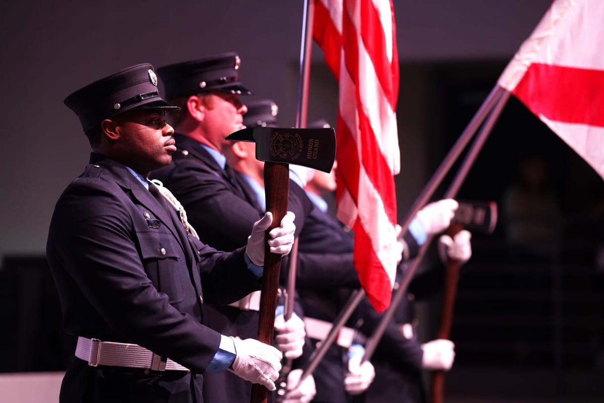Huntsville Fire and Rescue Honor Guard members standing at attention in dress uniforms during memorial ceremony