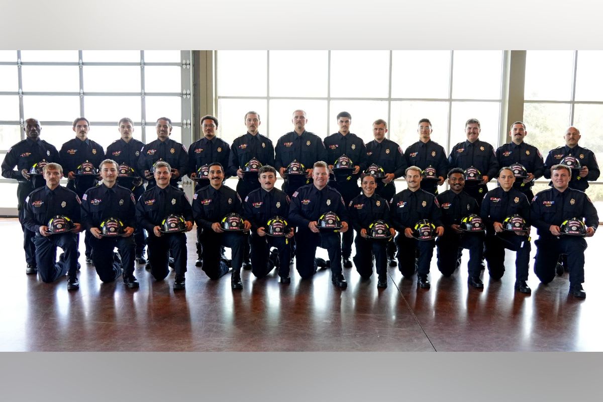Twenty-four newly sworn Clarksville firefighters standing in uniform at graduation ceremony
