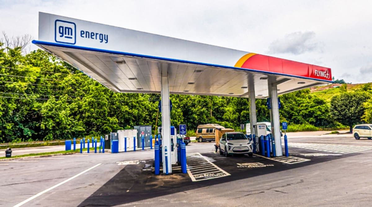 Modern electric vehicle charging station with pull-through design at highway rest stop
