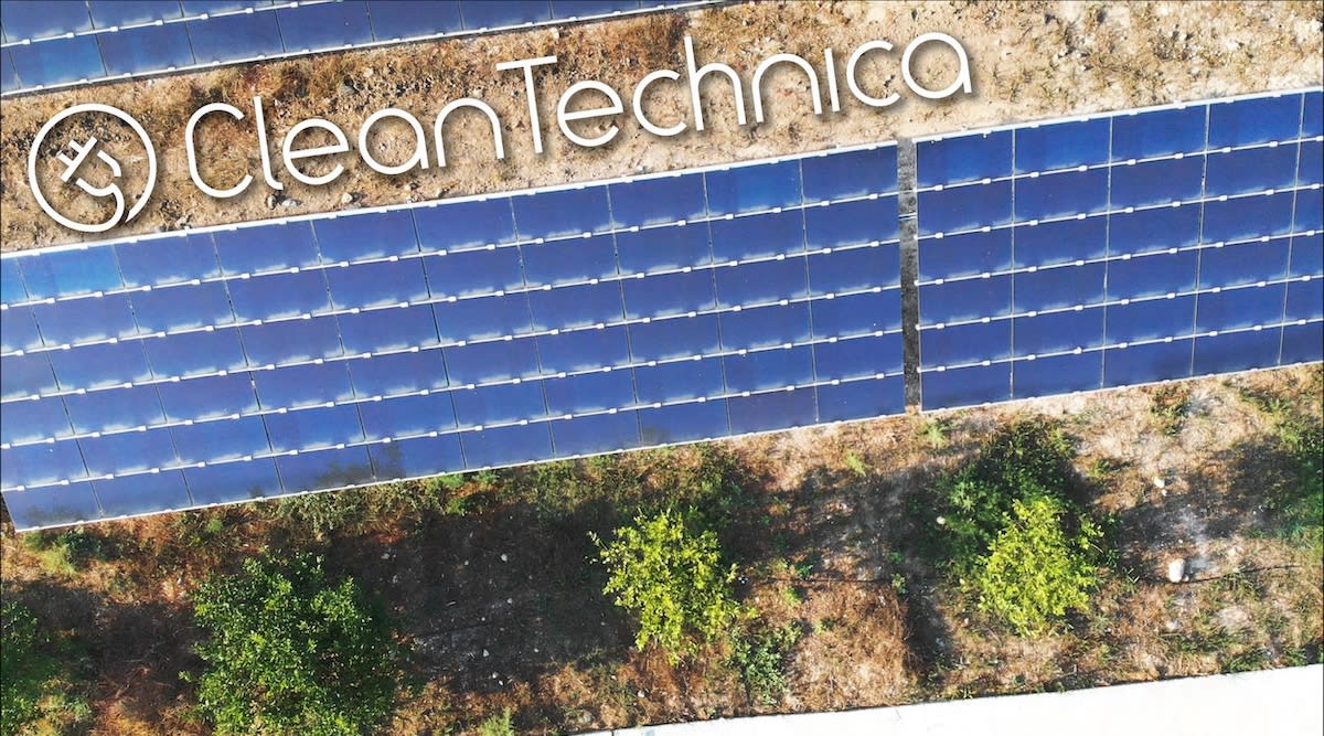 Solar panel array installed on Pennsylvania farmland under blue sky with rolling hills