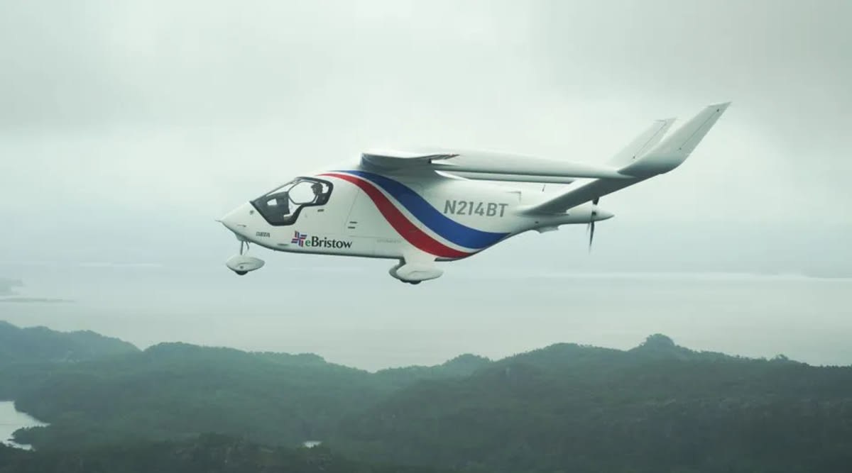 White electric ALIA CX300 aircraft on runway with mountains in background