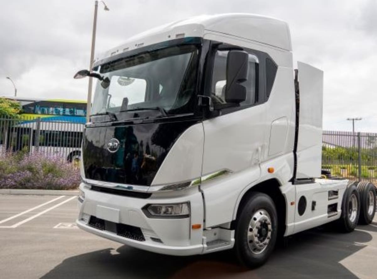 Large electric semi-truck charging at commercial charging station in California