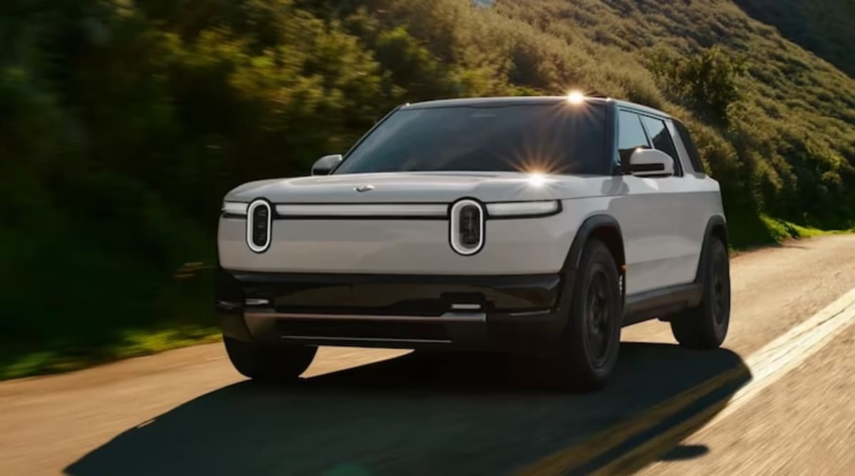 Rivian electric vehicle manufacturing facility in Normal, Illinois with workers on assembly line