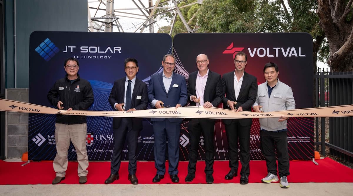 Researchers and energy company representatives stand together at Sydney apartment solar pilot launch event