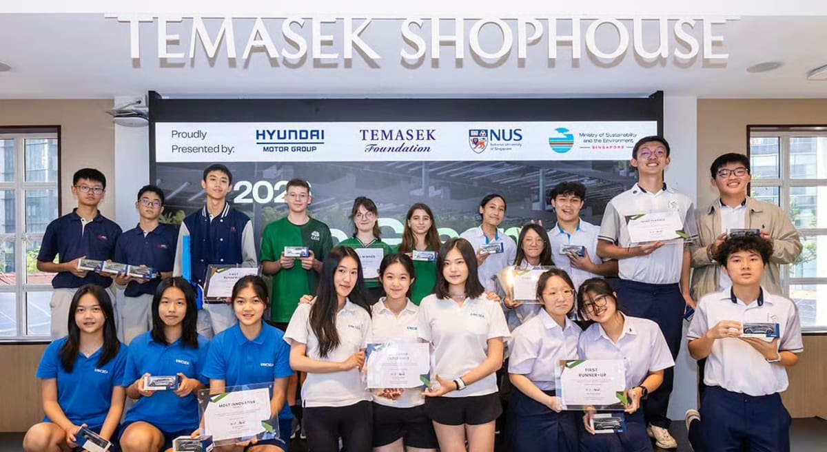 Diverse group of young students collaborating on climate solutions at Singapore hackathon event