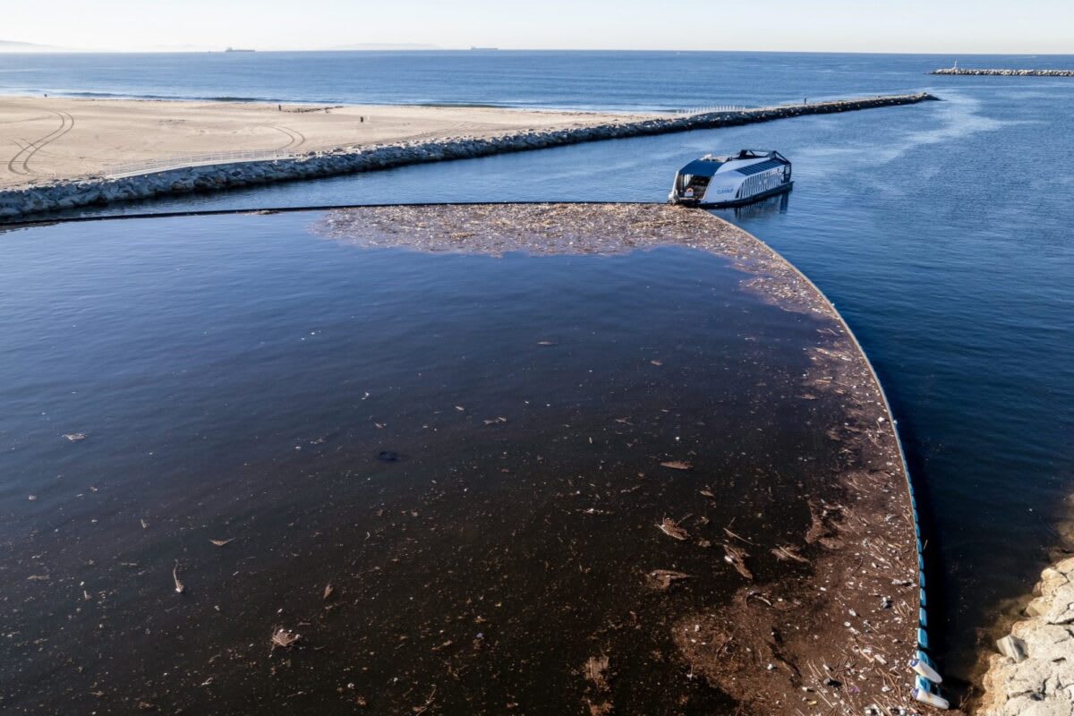Ocean Cleanup Interceptor floating device collecting trash in Ballona Creek near Santa Monica California